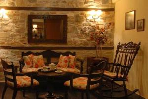 une salle à manger avec une table, des chaises et un miroir dans l'établissement To Patriko, à Elatochori