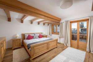 a bedroom with a bed with red pillows at Buccara Apartments Kitzbühel in Kitzbühel