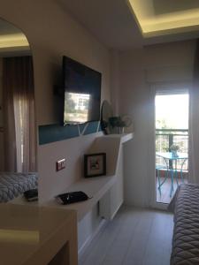 a living room with a tv on the wall at The Orange Apartments in Thessaloniki