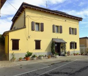 カルデラーラ・ディ・レーノにあるB&B Il Borghettoの茶褐色の襖葺き黄色の家