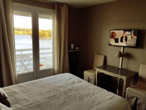 Postel nebo postele na pokoji v ubytování Hotel Restaurant La Caravelle