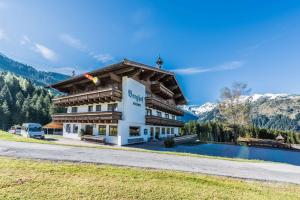 a building with a pool in front of a mountain at Almliesl HOLL-556 in Hollersbach im Pinzgau