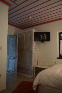a bedroom with a bed and a wooden ceiling at Argiades in Elati Zagori