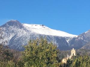 una montagna innevata con un edificio di fronte di Da Rinuccio a Milo