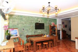 a dining room with a wooden table and chairs at 500Km Home in Hualien City