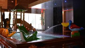 a childrens play area with a playground with a water fountain at Meresuu Spa & Hotel in Narva-Jõesuu