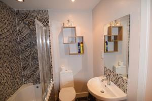 a bathroom with a toilet and a sink and a shower at Easby Hall 22 in Scarborough +38 photos