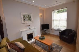 a living room with a couch and a fireplace at Easby Hall 22 in Scarborough
