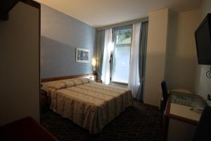 a hotel room with a bed and a window at Hotel San Terenzo in Lerici