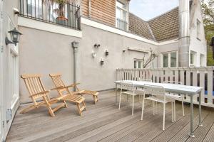 a patio with a table and chairs on a balcony at 2 BEDROOM CITY CENTER TERRACE in Amsterdam