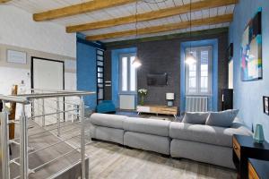 a living room with a couch and a table at Rome As You Feel - Design Apartment at Colosseum in Rome