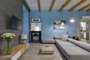a living room with a couch and a fireplace at Rome As You Feel - Design Apartment at Colosseum in Rome