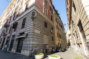 an old stone building on a city street at Rome As You Feel - Design Apartment at Colosseum in Rome