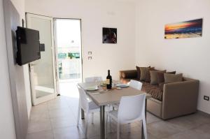 a living room with a table and a couch at Torre Lapillo GMA Tourism in Torre Lapillo