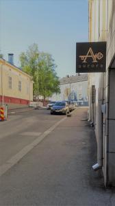a sign on the side of a building next to a street at Kesähotelli Aurora in Tampere