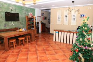 a living room with a christmas tree and a table at 500Km Home in Hualien City