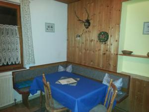 a dining room with a blue table and two chairs at Rottl-Sepp Renoth Karoline in Berchtesgaden