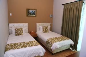 a room with two beds and a window at 500Km Home in Hualien City