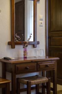 una toeletta in legno con specchio e due bicchieri di Elli Hotel a Skopelos Town
