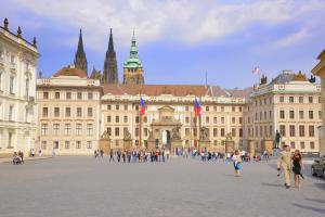 a group of people walking in front of a large building at Karlova Apartment in Prague