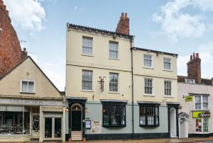 a large white building on the corner of a street at The LOCATION- 1 FREE PRIVATE PARKING SPACE - 60 SECOND WALK 2 MINSTER! in York