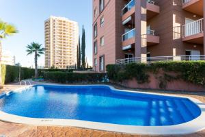 a swimming pool in front of a apartment building at Beach View Apartment Litoralmar in Portimão