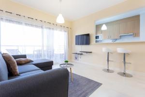 a living room with a couch and a table at Beach View Apartment Litoralmar in Portimão