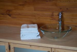 a bathroom sink with a faucet and towels on a counter at Château de Lastours in Valence-dʼAgen