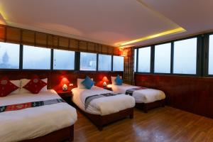 Postel nebo postele na pokoji v ubytování Anise Sapa Hotel + 37 fotografií
