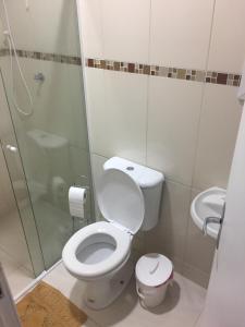 a bathroom with a toilet and a glass shower at Eco Isla GuestHouse in Florianópolis +35 photos