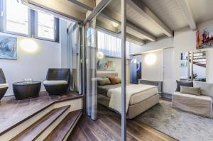 a bedroom with a bed and a couch in a room at Luxury Penthouse Venice in Venice