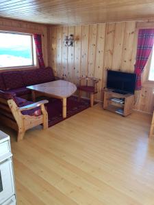 Телевизор и/или развлекательный центр в Fjellbu Two-bedroom Cottage