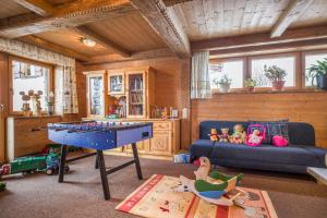 a living room with a pool table and a couch at Bauernhof Großwolfing- Appartementhaus Fischbacher in Ebbs
