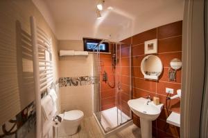 a bathroom with a toilet and a sink and a shower at Lenotti Bed and Breakfast in Campobasso