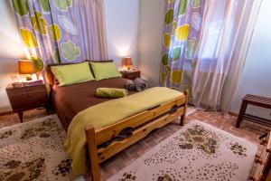a bedroom with a bed with a wooden frame at Lampreiko in Synikia Mesi Trikalon