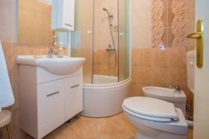 a bathroom with a toilet and a sink and a shower at Apartment Mirjana in Poreč +16 photos