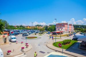 a city street with cars parked in a parking lot at Apartment Mirjana in Poreč