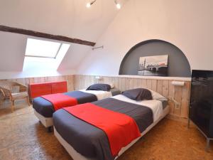 two beds are in a room with a window at Charming farmhouse in Waimes with swimming pool and sauna in Waimes