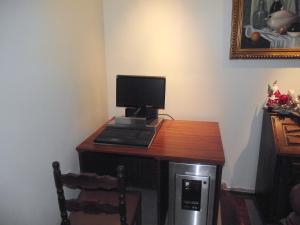 a laptop computer sitting on top of a wooden table at Hotel Dom Sancho I in Lisbon