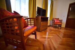 a living room with two chairs and a television at Thalia Apartment in Sibiu