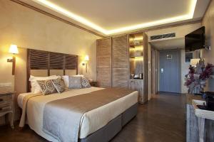 a bedroom with a large bed and a television at Congo Palace in Athens