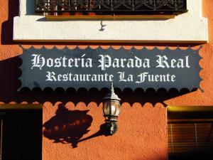 a sign on the side of a building with a street light at Casa Rural Parada Real CR-CC-00258 in Garganta la Olla