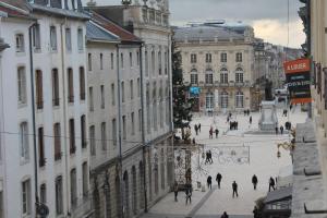 a group of people walking down a city street at Les Portes d'Or in Nancy