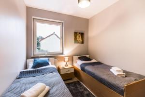 Posteľ alebo postele v izbe v ubytovaní APARTAMENTY GORZÓW WLKP.