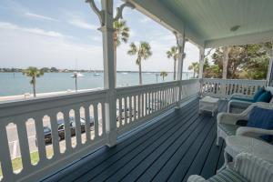 a porch with chairs and a view of the water at Bayfront Westcott House Bed & Breakfast in St. Augustine