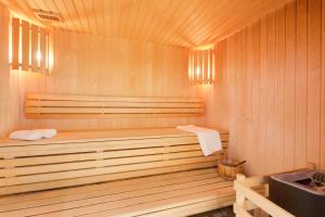 a sauna with a wooden tub in a room at Residence Chalet de l'Adonis in Les Menuires