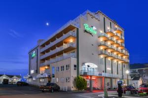 a hotel building with a parking meter in front of it at Paradise Plaza Inn in Ocean City