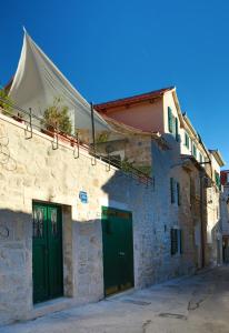 a building with two green doors on a street at Divota Apartment Hotel in Split