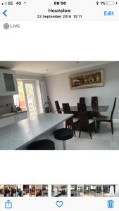 a kitchen with a dining room table and chairs at House in Hounslow