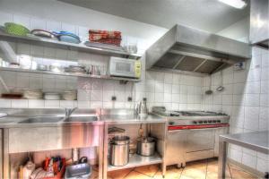 a kitchen with a sink and a stove at Le Chalet Joly in Brides-les-Bains